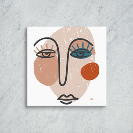 Abstract art print of a face on a textured wall