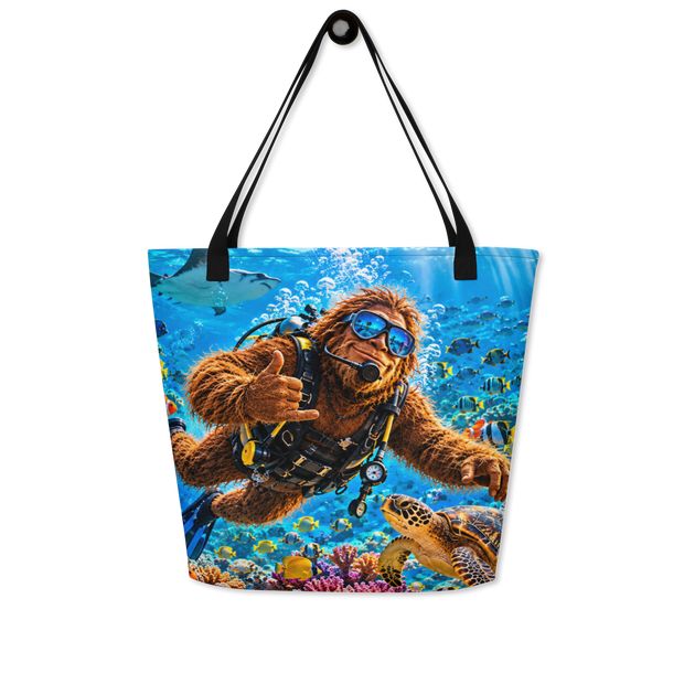 A tote bag with black shoulder straps, featuring a colorful printed graphic of Bigfoot in scuba gear swimming underwater with a sea turtle and coral reef.