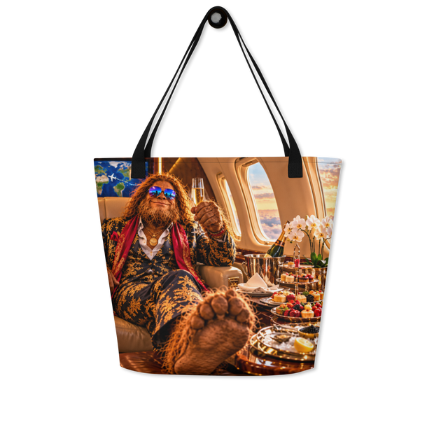 A tote bag with black shoulder straps, featuring a graphic of Bigfoot in a luxurious airplane cabin holding a champagne flute.