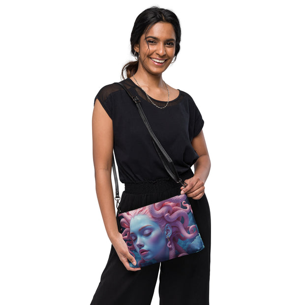 A crossbody bag featuring a detailed fantasy illustration of Pink Medusa, a mythological beauty, shown on a clean white background.