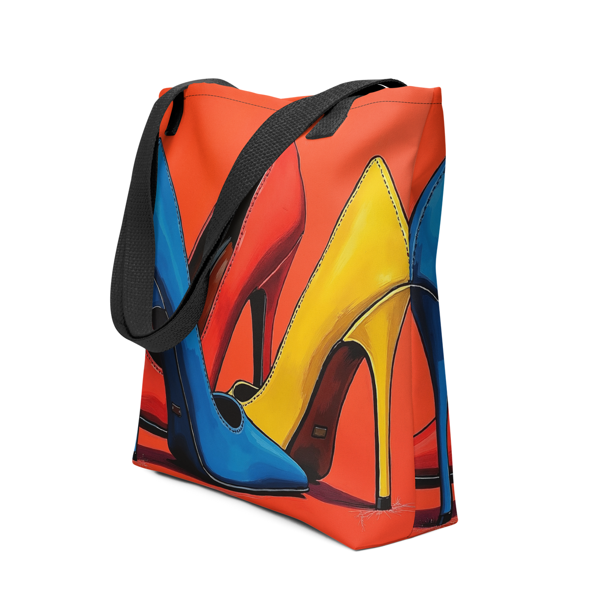 A canvas tote bag featuring a colorful graphic print of three high-heeled shoes in blue, yellow, and red-orange, with black shoulder straps, shown on a plain white background.