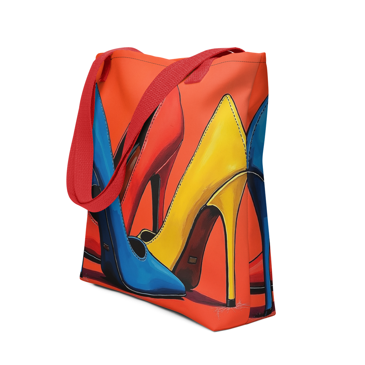 A canvas tote bag with a vibrant graphic print of three high-heeled shoes in blue, yellow, and red-orange, featuring red shoulder straps, shown on a plain white background.
