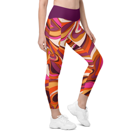 A model wearing high-waisted leggings with a bold, retro 1970s-style abstract swirl pattern in orange, pink, purple, and cream, paired with white sneakers on a solid white background.