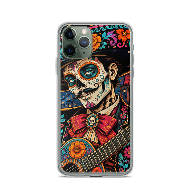 A clear iPhone case featuring a colorful Day of the Dead (Dia de los Muertos) illustration of a man with sugar skull makeup, a large red bow tie, and an acoustic guitar, shown on a white background.